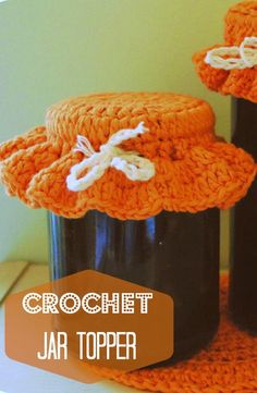 crochet jar topper with two jars in the middle and an orange hat on top