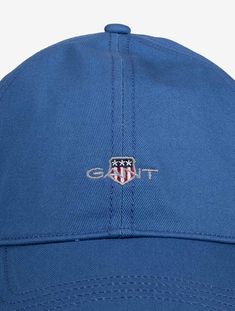 A sporty staple for any wardrobe, this cap is designed with six panels and a regular, adjustable fit. It's embroidered with our signature small-scale shield graphic on the front and engraved with our GANT logo on the back metal buckle. Fabric Composition: 100% Cotton Unisex fit GANT graphic embroidered on front GANT branded metal buckle 6 Panels Classic Blue Baseball Cap For Sports, Blue Six-panel Baseball Cap With Embroidered Logo, Classic Blue Baseball Cap For Outdoor, Blue Baseball Cap With Embroidered Logo Visor, Classic Blue Outdoor Baseball Cap, Blue 5-panel Baseball Cap For Sports Events, Blue Outdoor Hat With Embroidered Logo, Sporty Blue Six-panel Baseball Cap, Classic Blue Baseball Cap With Curved Visor