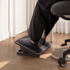 a person standing on a chair with their feet up