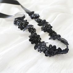 "Beautiful and lovely black color embroidery flower lace sash. You can use it for a head tie ( headband ) or sash. Sequins and beads hand sew on double-layer embroidery flower lace. Also, hand sews with 7/8\" black color satin ribbon on each side. Your beautiful sash/ headband will come in a lovelike gift box. +1.5\" width flower lace portion 18\" long +7/8\" black satin ribbon +Adult Sash 105\" / Flower Girl Sash 78\" / Headband 78\" If you have any questions, please just convo me. Thanks :) ♥ Elegant Black Party Sash, Lace Party Headband, Adjustable Black Ribbon Headband, Lace Headband For Party, Elegant Sashes With Handmade Flowers For Party, Elegant Handmade Flower Sashes For Party, Black Ribbon Headband, Lace Sash, Bridesmaid Sash