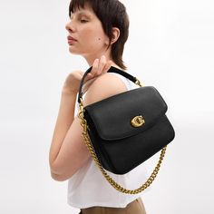 A more compact Cassie our 19 is smaller than the original and made for days or nights on the go. The polished pebble leather design is finished with a Signature turnlock closure and three interchangeable straps for versatile styling. Detach the crossbody strap and carry by hand with the leather and chain top handles together or separately. | Coach Cassie Crossbody Bag 19 - Women's Designer Crossbody - Brass/black Coach Cassie Bag, Versatile Coach Bag With Detachable Strap, Versatile Coach Bag With Adjustable Strap, Pebbled Leather Satchel With Detachable Strap For Work, Workwear Satchel With Detachable Strap In Pebbled Leather, Versatile Coach Bags With Detachable Handle, Workwear Pebbled Leather Crossbody Satchel, Everyday Timeless Flap Bag With Metal Hardware, Timeless Everyday Flap Bag With Metal Hardware