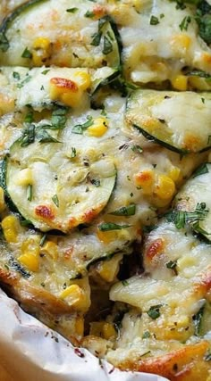 a casserole dish with zucchini, corn and cheese