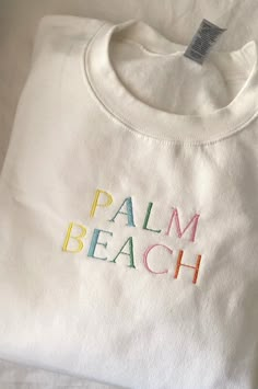 This  Palm Beach design is perfect for a gift or just for yourself. Please have a look at our size chart in the photo carousel. - 50% cotton, 50% polyester - pill-resistant air jet yarn - double-needle stitching throughout - set-in sleeves - 1x1 ribbed collar, cuffs and waistband with spandex - Safety Orange is compliant with ANSI - ISEA 107 High Visibility Standards - Tear away label Palm Beach Sweatshirt, Sweatshirt On The Beach, Preppy Embroidery Designs, White Long Sleeve T-shirt For Beach Season, White Tops With Letter Embroidery For Spring, Embroidered Cotton T-shirt For Beach, White T-shirt With Letter Embroidery For Spring, White Letter Embroidery T-shirt For Spring, White Embroidered T-shirt For Spring