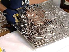 a person is working on an intricate metal design