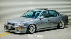 a silver car parked in front of a garage door