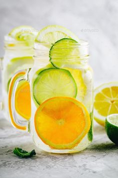 two mason jars filled with lemon, lime and limeade - stock photo - images