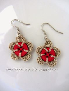 the earrings are decorated with red flowers