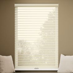 two white pillows sitting on top of a window sill