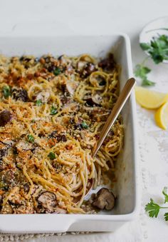 a casserole dish with pasta, mushrooms and parmesan cheese