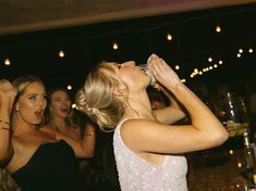 a group of women standing next to each other at a party