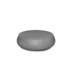 a round metal object sitting on top of a white surface with no one around it