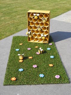 a beehive made out of honeycombs sitting on the grass