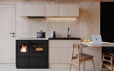 a kitchen area with an oven, table and chairs in front of the counter top