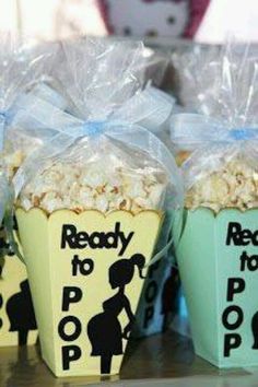 two buckets filled with popcorn sitting on top of a table