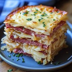 a stack of lasagna stacked on top of each other with cheese and meat