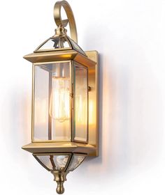 an old fashioned brass wall light with two lights on the front and one light on the back