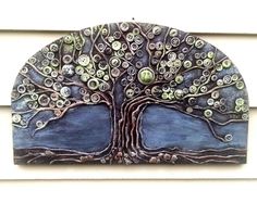 a metal wall hanging with a tree on it