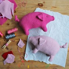 pink felt pigs and other crafting supplies laid out on a table