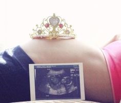 the back of a woman's head with a tiara on top of it