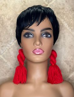 a female mannequin head with red tassels on it's ears