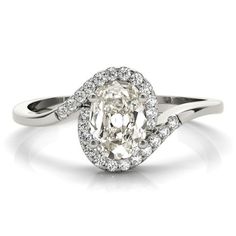 an oval shaped diamond ring with two rows of diamonds around it