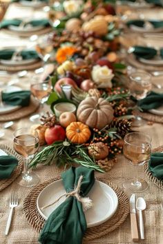 the table is set with place settings, napkins and silverware for an elegant thanksgiving dinner