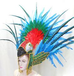 a woman wearing a colorful headpiece with feathers