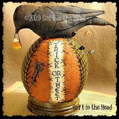 a bird is perched on top of an old ball with writing and keys in it