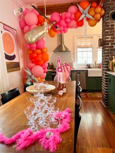 Vueve before vows bachelorette party decor, champagne party, champagne glasses, orange and pink balloons, ring finger foam finger, Bach babes, balloons, pop the bubbly SHES getting a hubby, balloon arch in background of table set up for a bachelorette party in Charleston Bachelorette Veuve Theme, Pop The Bubbly Shes Getting A Hubby Bachelorette, Hot Pink And Orange Bachelorette Party, Craft Night Bachelorette Party, Carnival Bachelorette Party, Pink And Orange Bachelorette Party Outfit, Bachelorette Party Themes Colorful, Pink And Orange Disco Bachelorette, Red Orange Pink Bachelorette