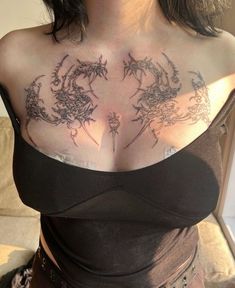 a woman with tattoos on her chest