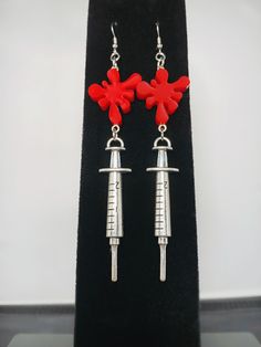 These handmade earrings feature hand poured blood splatter plastic charms and 3D syringe charms. Approx. 4 inches in length. ◆ PLEASE READ MY SHOP FAQ OR MESSAGE ME WITH ANY QUESTIONS BEFORE PLACING AN ORDER. *ALL SALES ARE FINAL* ◆ Processing time; please allow 1-7 days for order(s) to be made and packaged. Item(s) will be processed and shipped sooner if they are already pre-made and in stock. Thank you for your patience!  ◆Shipping time; once an order has been processed and dropped off at the Plastic Charms, Blood Splatter, Horror Punk, Medical Nurse, Punk Earrings, Hand Poured, Handmade Earrings, Jewelry Earrings Dangle, Etsy Earrings