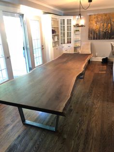 a large wooden table sitting in the middle of a living room