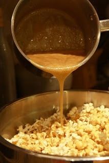 the sauce is being poured into the pot full of popcorn and it's ready to be cooked