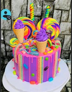 there is a cake decorated with candy and lollipops