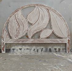 a decorative metal headboard made to look like leaves