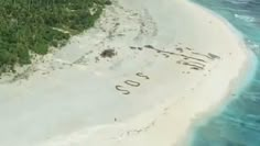 an aerial view of a beach with the number 350 written in sand next to it