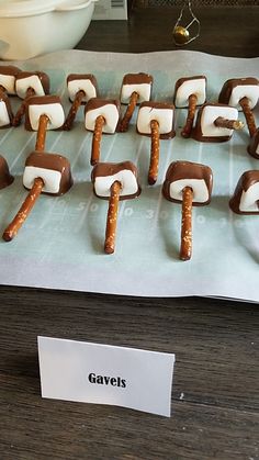 there are marshmallows and pretzels arranged on the table for display