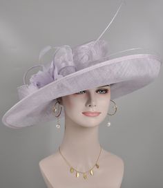 "https://www.youtube.com/shorts/0SWUprbeWfw With my little son's help, I finished the video on Youtube, it is very hard for the people to get a right size hat due to the big head size, please check the video, it will help you.  Description: This beautiful sinamay hat is an elegant wear at any church or derby event. its sinamay material is not too intimidating and attracts the eye. The chic flower adnorment that rests on the wide, side sweep brim is complemented by sinamay accentuations. Material: Sinamay with feathers Crown Width; 8 inch Crown Height: 4 inch Brim Width: 18 inches Head girth is from 22' to 23.22 \" adjustable size fits  most with an adjustable cord strap for the smaller fit If you need to  some colors on the hat to match your dress, please let me know Color on screen may va Elegant Purple Hats For Spring, Elegant Purple Hat For Spring, Spring Formal Lavender Hat, Elegant Purple Hats For Kentucky Derby, Elegant Purple Hat For Church, Elegant Lavender Hats With Short Brim, Elegant Purple Fascinator For Wedding, Elegant Lavender Hat With Short Brim, Elegant Lavender Mini Hat With Curved Brim