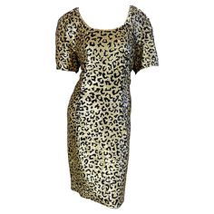 Fabulous 1980s vintage OLEG CASSINI fully sequined leopard print short sleeve silk dress ! Features thousands of hand-sewn gold and black sequins throughout the entire dress. Hidden zipper up the back with hook-and-eye closure. Great belted or alone. The pictured 90s Jane August black patent croc embossed belt is also available in my 1stDibs Shop. In great condition US Size 12 / 14 Measurements: 40 inch bust 34 inch waist 40 inch hips 38.5 inches from top back shoulder seam to hem Leopard Print Short Sleeve Party Dress, Short Sleeve Leopard Print Party Dress, Leopard Print Shorts, Oleg Cassini, 80s Dress, Vestidos Vintage, Leopard Animal, 1980s Vintage, Black Sequins