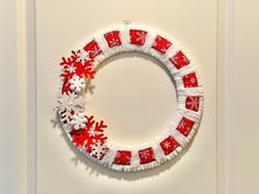 a red and white wreath with snowflakes on it