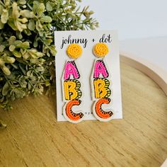 Add some fun and color to look with our fun Beaded ABC Earrings! In playful pink, yellow, and orange hues, these lightweight earrings are perfect for teachers and students alike! Details: Super lightweight at just 0.2 ounces Measures approximately 3 inches long x 3/4 inches wide Post backing Nickel-free Reverse side is a felt lining Orange Hues, Lightweight Earrings, Everyday Earrings, Appreciation Gifts, Light Weight Earrings, Teacher Appreciation Gifts, Teardrop Earrings, Earring Gifts, Pink Yellow