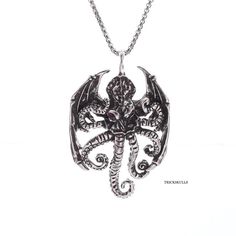 Winged Octopus Skull Cthulhu Demon Bat Pendant Includes A 60cm Stainless Steel Round Box Chain. New & Sealed! This New Winged Octopus Pendant Has A Modern Retro Style. The Detailed Alloy Casted Pendant Measures 6 X 4 Cm, Or 2.36 X 1.57 Inches And Includes A 60cm Stainless Steel Round Box Chain. Scary Details Include The Rose Lab Gem Eyes, Curled Tentacles, Bat Wings And Mad Octopus Face. This Rebel Accessory Also Makes A Great Gift. Ships Free, New And Sealed In A Velvet Jewelry Pouch. See Our O Octopus Face, Octopus Skull, Gem Eyes, Gothic Party, Raven Jewelry, Hip Hop Accessories, Bat Pendant, Octopus Pendant, Punk Accessories