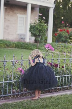 "Flower Girl Black Tutu Dress, Flower Girl Black Dress - Fully Sewn This black tutu girl dress is FULLY SEWN on satin like fabric bodice (not knotted to crochet headbands like most other companies on Etsy show). The tutu skirt (dress bottom) is made with hundreds of yards of the most premium apparel tulle. The dress bodice is elasticized in the back and is embellished with 4 boutique frayed roses with a shiny rhinestone centerpiece (buttons may vary upon availability). Absolutely stunning and is Older Flower Girl Dresses, Older Flower Girl, Breakfast At Tiffany's Dress, Black Tutu Dress, Black Flower Girl, Black Flower Girl Dress, Twirling Dress, Black Tulle Dress, Black Tutu