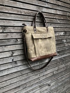 Briefcase made from heavy weight waxed filter twill in the colour ranger tan and oiled leather in the color bordeaux brown, I love the combination of these to materials. I made it big enough for laptop , and all your other necessaties. This bag is lined with a cotton canvas and there is a double inside pocket on one side. There is a large outside pocket where you can store your laptop charger and other stuff and a luggage handle attachment on the back side It closes with a metal zipper and the s Men Purse, Wax Canvas, Canvas Satchel, Man Purse, Laptop Charger, Denim Crafts, Waxed Canvas, Metal Zipper, Bag Bag