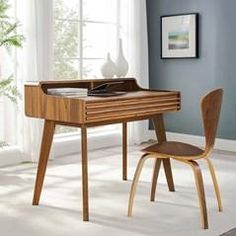 a wooden desk and chair in front of a window