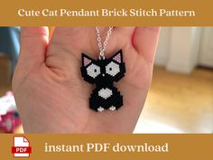 a hand holding a black and white cat beaded necklace with the words cute cat pendant brick stitch pattern on it