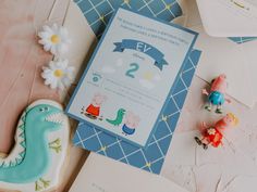 a blue and white birthday party with cookies, toys and decorations on the table next to it