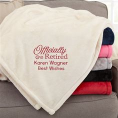 towels stacked on top of each other in front of a couch with the words, officially retired and best wishes