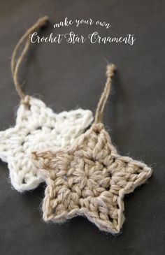 a crocheted star ornament hanging from a string on a black surface