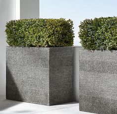 two square planters are sitting next to each other